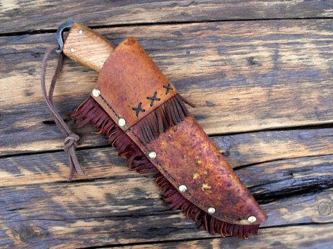 custom period frontier belt knife with a decorated rawhide sheath