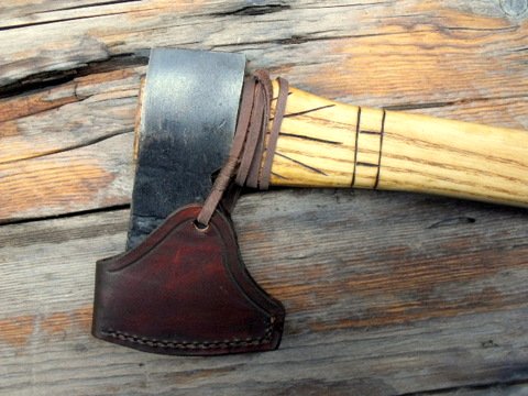 custom colonial axe with a leather sheath.